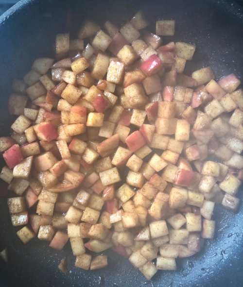 apples being cooked in a skillet